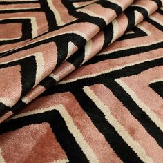 a close up view of a pink and black rug