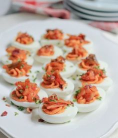 deviled eggs are arranged on a white plate