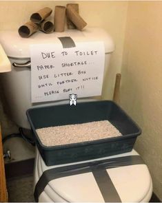 a toilet with a sign on the lid that says dive to toilet paper shotate use little box