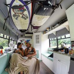 two women sitting in the back of a bus