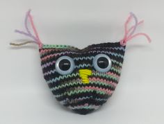 a knitted bird with big eyes on it's head