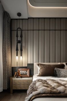 a large bed sitting next to a lamp on top of a wooden headboard in a bedroom