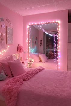 a bedroom with pink walls and lights on the wall, bed in front of mirror