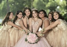 a group of young women in dresses posing for a photo with their bridesmaids