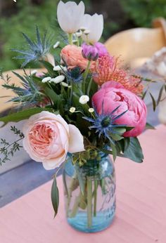 a vase filled with flowers sitting on top of a table