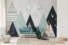 a living room decorated with christmas trees and geometric wallpaper in shades of blue, green, grey and white