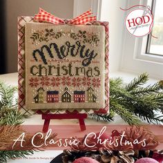 a cross stitch christmas card on a table