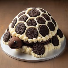 a tortoise shell cake with chocolate cookies on the top and white frosting