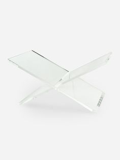 a clear glass table with two legs on the top and one leg raised up in the air