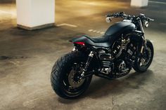 a black motorcycle parked in an empty parking lot