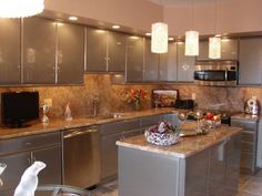 a modern kitchen with stainless steel appliances and granite counter tops is pictured in this image