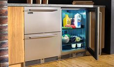 an open refrigerator in a kitchen next to a counter