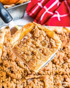 a spoonful of apple crisper pie being lifted from a casserole dish