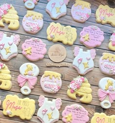 baby shower cookies are arranged on a wooden table