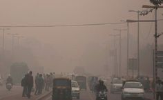 cars, motorcycles and pedestrians on a foggy street