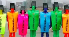 five people in colorful plastic bags standing next to each other