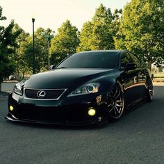 a black car is parked on the street