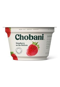 yogurt with strawberries on the bottom is shown in front of a white background