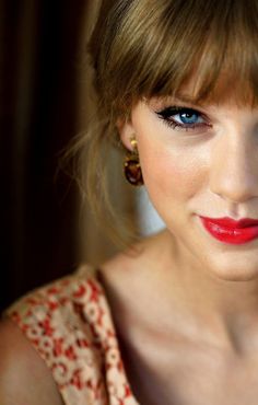 a close up of a person wearing red lipstick