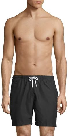 a man with no shirt on wearing blue swim trunks and swimming trunks that have white drawstrings