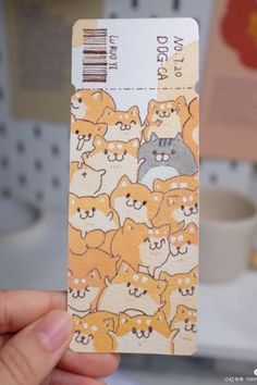 a person holding up a ticket with cats on it