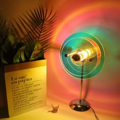 a lamp that is sitting next to a plant