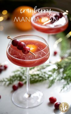 the cranberry manhattan cocktail is garnished with cherries