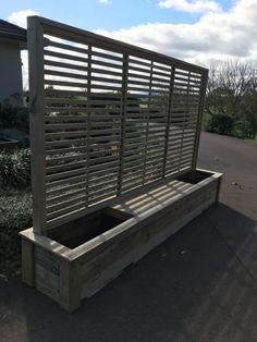 a wooden bench sitting on top of a sidewalk