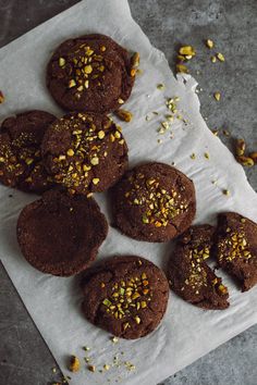 chocolate cookies with pistachios are on a napkin