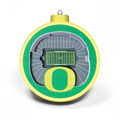 an ornament shaped like a football stadium with the letter o in green and yellow