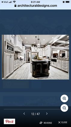 an image of a kitchen with white cabinets and black counter tops on the phone screen