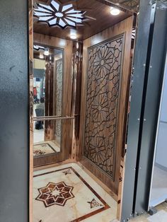 the inside of a room with wooden doors and decorative tiles on the floor, along with an intricately designed door