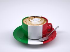 a cappuccino with the italian flag painted on it is sitting on a saucer