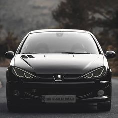 a black car parked on the side of a road