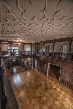 the inside of an old building with wood flooring and decorative ceiling tiles on the walls