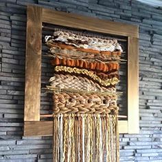 a wall hanging made out of different types of rope and wood with a wooden frame