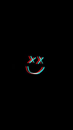 a smiley face is lit up in the dark with red and blue lights on it