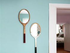 a racket mirror is hanging on the wall next to a mirror that says, careful now, your tennis racket's mirror, mirror, mirror, mirr, on the wall may have a backhanded response