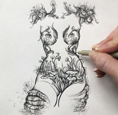 a person is drawing something with pencils on paper