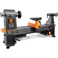 a table top sawing machine with an orange handle on it's blades