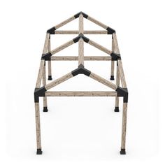 a wooden structure made out of black and white pegs on top of it's sides