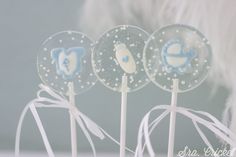 three baby shower lollipops on top of each other with white bows and blue designs