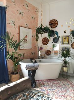 a bath tub sitting next to a toilet in a bathroom