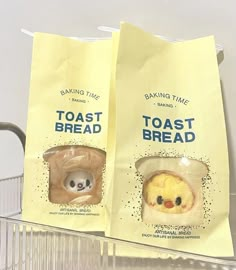 two bags of toast bread sitting next to each other on a shelf in a store