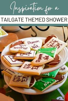 some cookies that are on a plate with the words congratulations for a tailgate themed shower