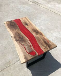 a wooden table with red paint on it