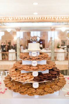 the wedding cake has cookies on it and is displayed in front of an instagram page