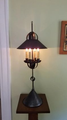 a table lamp sitting on top of a wooden stand