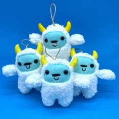 a group of stuffed animals with horns on their heads and eyes are hanging from strings