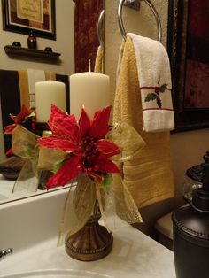 a bathroom sink with towels and candles on it